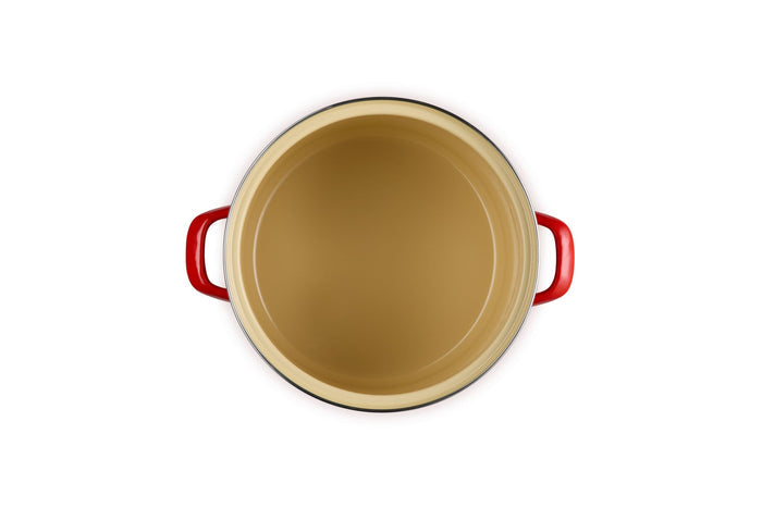 Beige inside stockpot with cerise handles on a white background