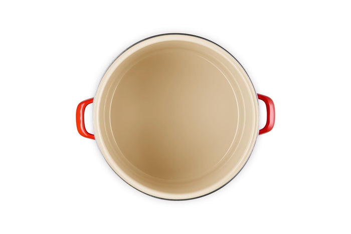 Beige inside stockpot with cerise handles on a white background