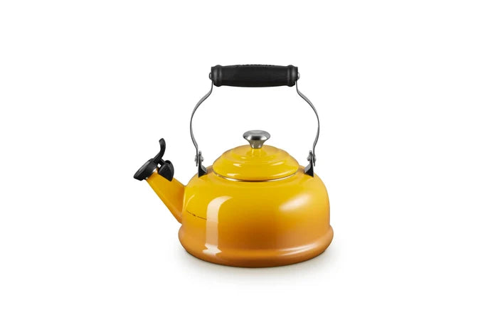 A glossy yellow-orange enamel kettle with a black handle and spout lever, isolated on a white background.