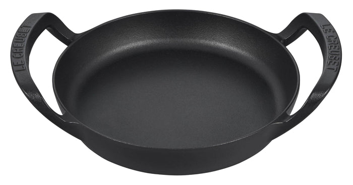Black cast iron skillet with handles on a white background