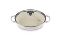 A shallot Le Creuset Enameled Cast Iron Signature Round Braiser with a glass lid on a white background