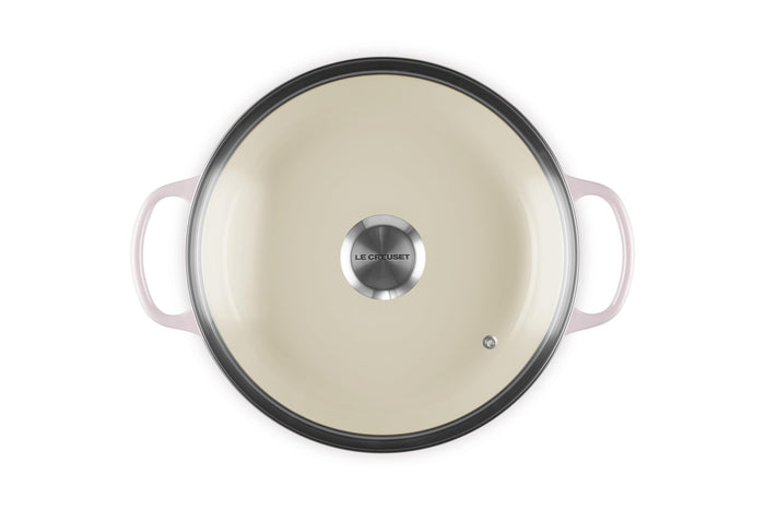 A shallot Le Creuset Enameled Cast Iron Signature Round Braiser with a glass lid on a white background