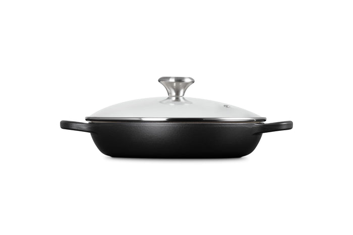 A licorice Le Creuset Enameled Cast Iron Signature Round Braiser with a glass lid on a white background