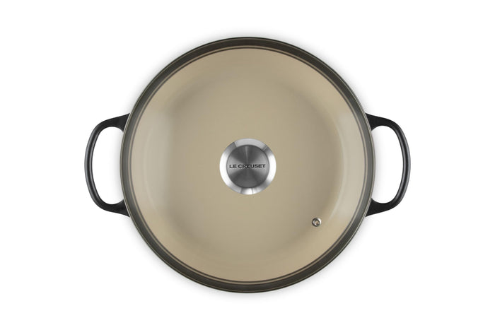 A licorice Le Creuset Enameled Cast Iron Signature Round Braiser with a glass lid on a white background