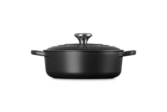 Side view of 3.5 qt Licorice Le Creuset Signature Round Wide Dutch Oven with a lid displayed on a white background