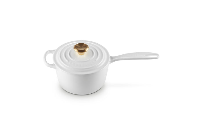 White enameled cast iron cookware pot with lid on a white background