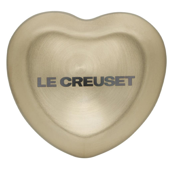 Top view of Le Creuset Figural Heart Knob - Light Gold - Large (45mm) displayed on a white background