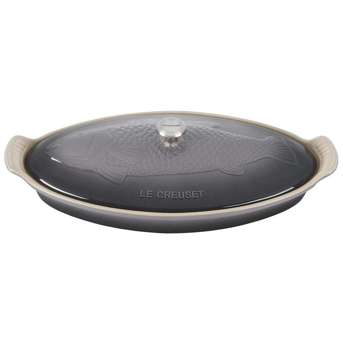 Oyster ceramic dish with fish design and 'Le Creuset' branding on a white background