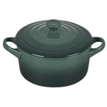 Green Le Creuset Mini Round Cocotte 14 oz with lid displayed on a white background