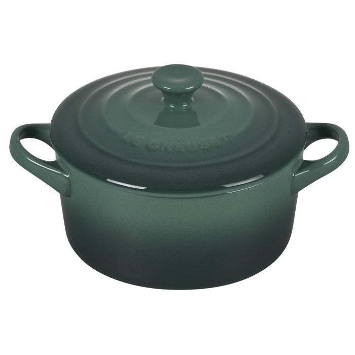 Green Le Creuset Mini Round Cocotte 14 oz with lid displayed on a white background