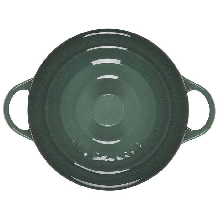 Top view of green Le Creuset Mini Round Cocotte 14 oz with lid displayed on a white background
