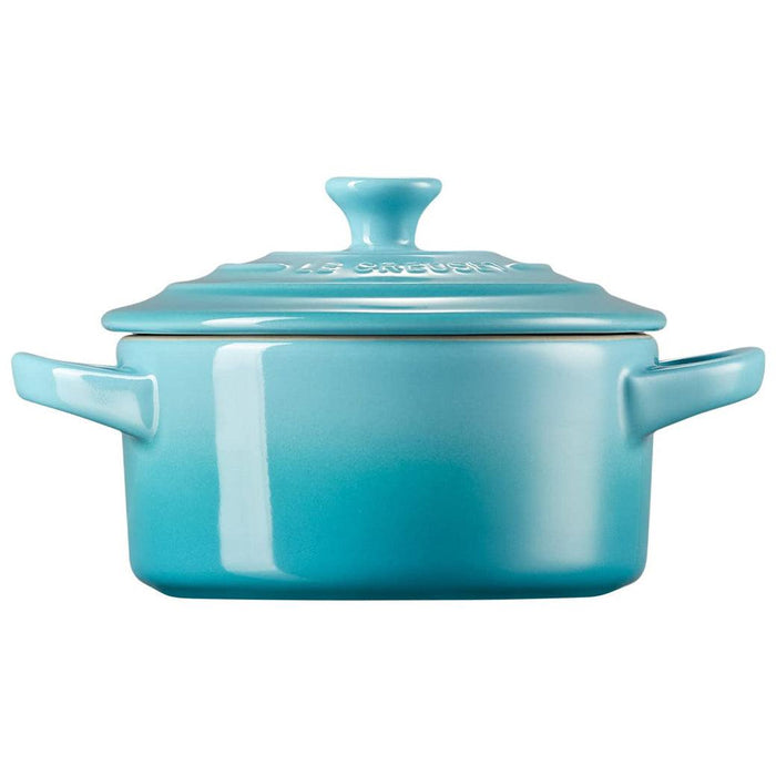 Side view of Caribbean Le Creuset Mini Round Cocotte 8 oz displayed on a white background