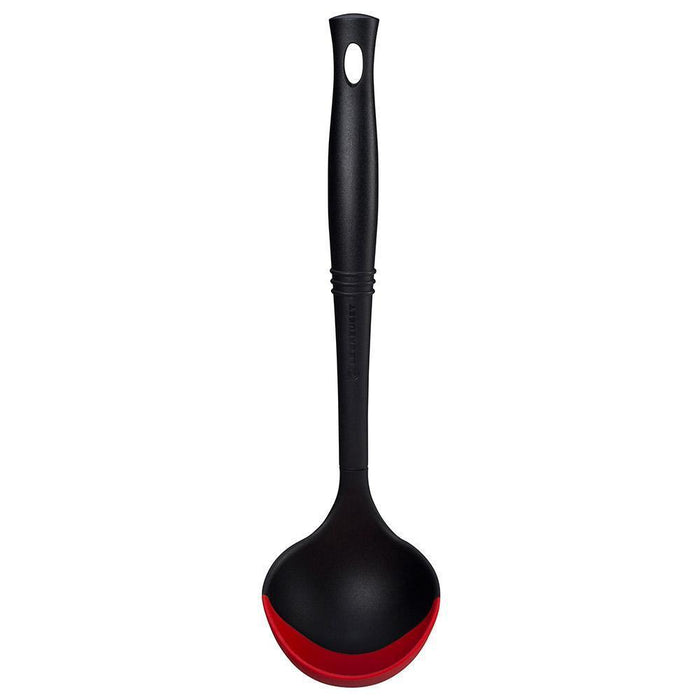 Cerise Le Creuset Revolution Bi-Material Ladle displayed vertically on a white background