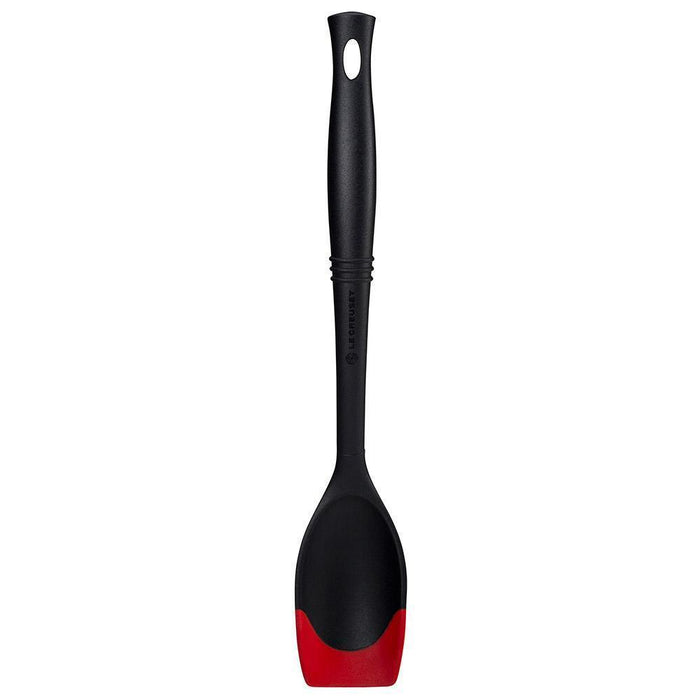 Cerise Le Creuset Revolution Bi-Material Saute Spoon displayed vertically on a white background