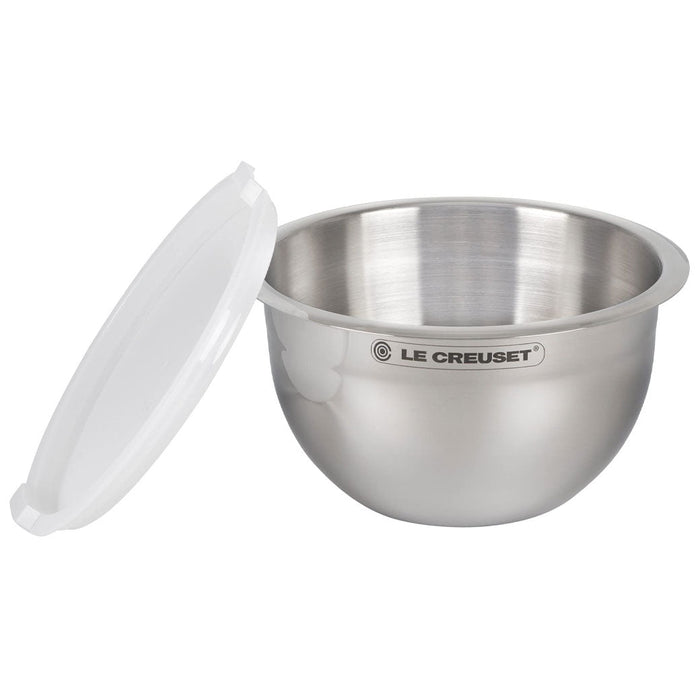 Le Creuset stainless steel mixing bowl with lid on the side displayed on a white background