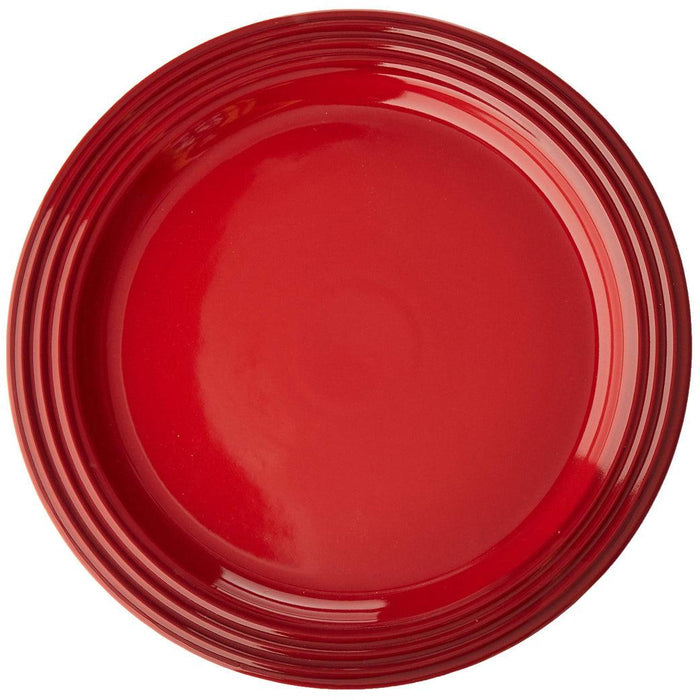 Top view of cerise Le Creuset 10.5″ Dinner Plate displayed on a white background