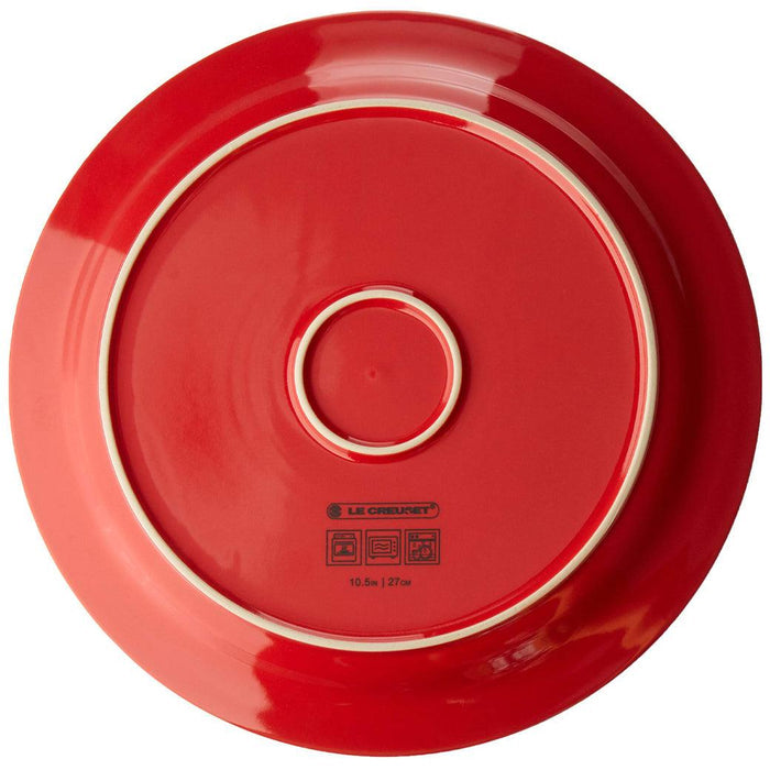 Bottom view of cerise Le Creuset 10.5″ Dinner Plate displayed on a white background