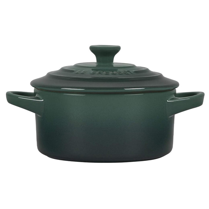 Side view of green Le Creuset Cocottes with lid displayed on a white background