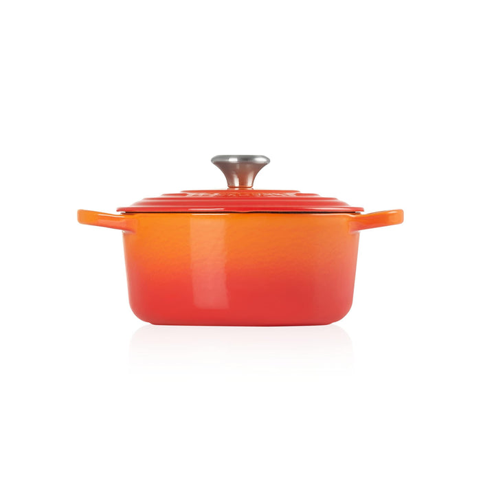 Side view of flame Le Creuset Signature Round 2 Qt. Dutch Oven with lid displayed on a white background