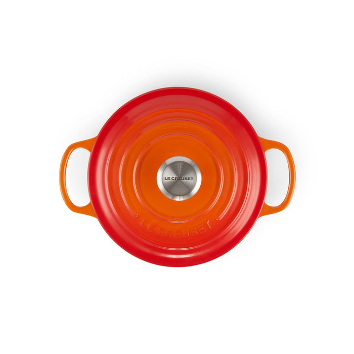 Top view of flame Le Creuset Signature Round 2 Qt. Dutch Oven with lid displayed on a white background