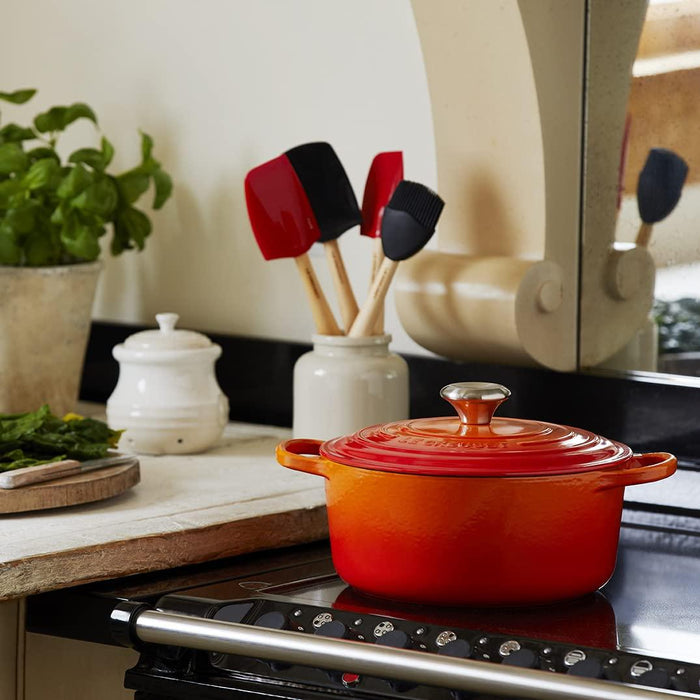 Flame Le Creuset Signature Round 2 Qt. Dutch Oven placed on a stovetop in a kitchen setting