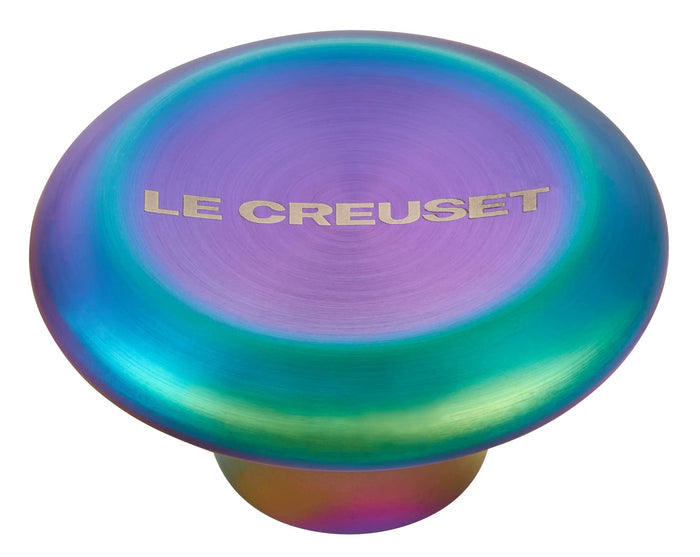 Iridescent kitchen knob with 'Le Creuset' branding on a white background