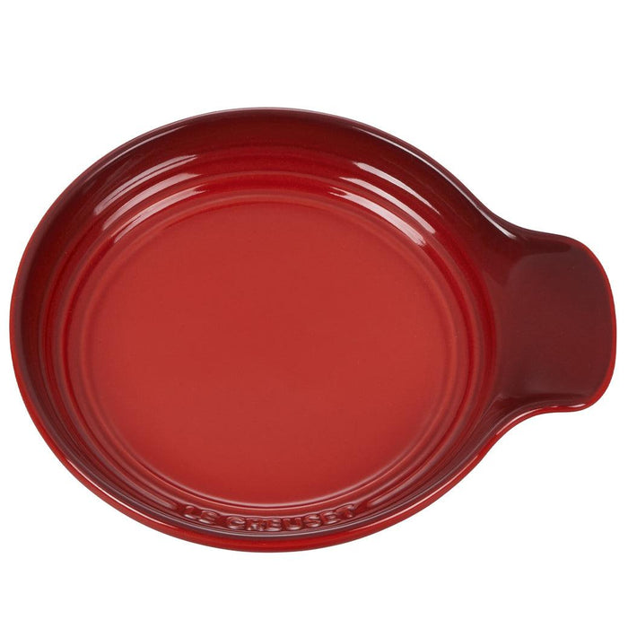 Top view of Cerise Le Creuset Signature Stoneware Spoon Rest, 6″ displayed on a white background
