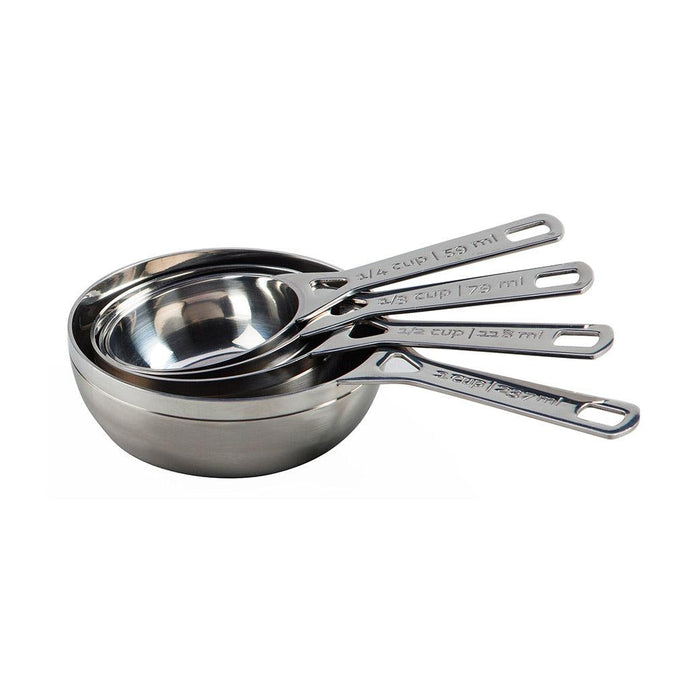 Le Creuset Stainless Steel Measuring Cups stacked on each other displayed on a white background