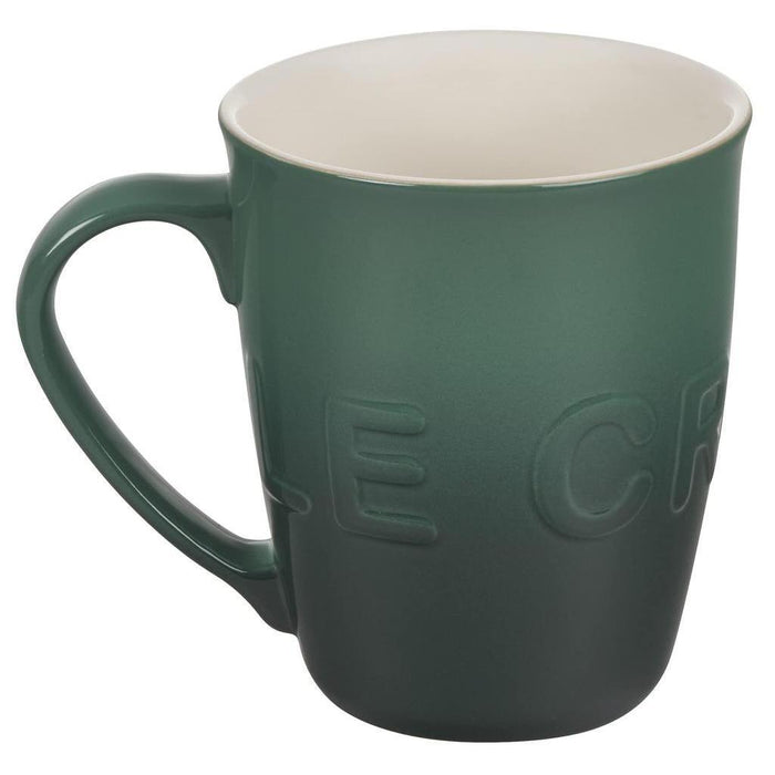 20 oz artichaut Le Creuset stoneware coffee mug displayed on a white background