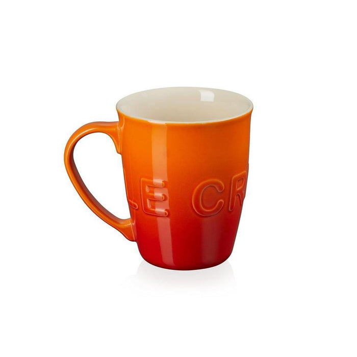 20 oz flame Le Creuset stoneware coffee mug displayed on a white background