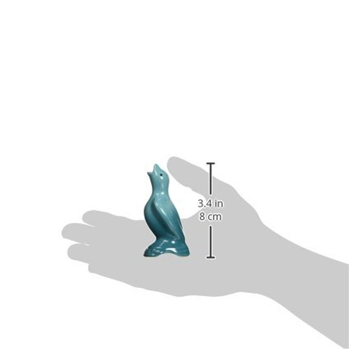 Someone holding Caribbean Le Creuset Stoneware Pie Bird with dimensions displayed on a white background