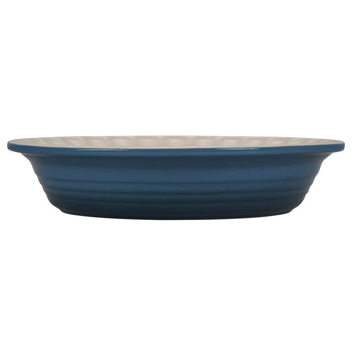 Side view of deep teal Le Creuset Stoneware Pie Dish displayed on a white background