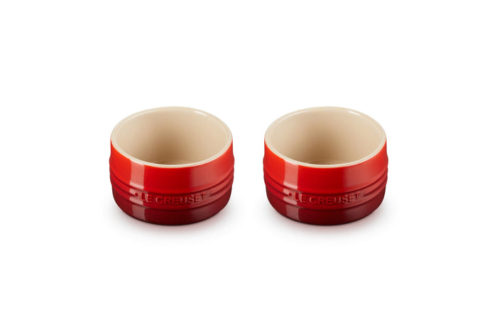 Set of two cerise Le Creuset stoneware round ramekin straight wall on a white background