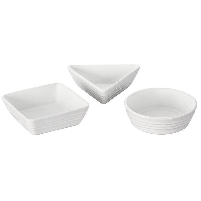 Set of 3 white Le Creuset stoneware tapas dishes of different shapes displayed on a white background