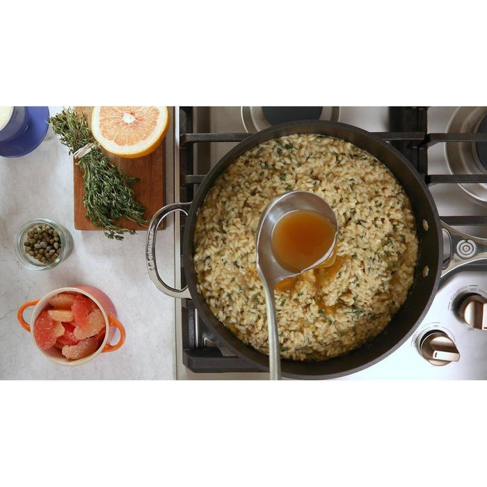 Top view of rice soup dish inside Le Creuset Toughened Nonstick PRO 3.5 qt. Sauté Pan on a stove range