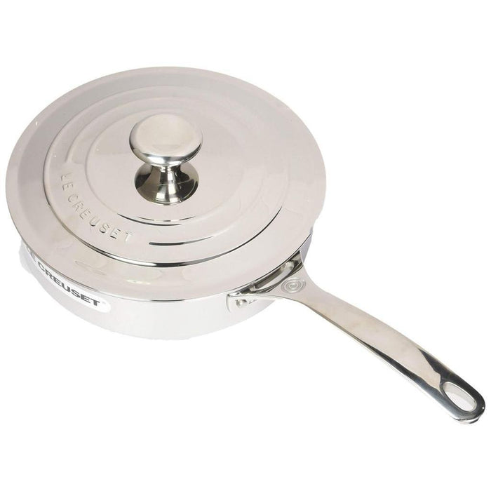 Top view of 3 qt Le Creuset stainless steel saute pan with lid on a white background