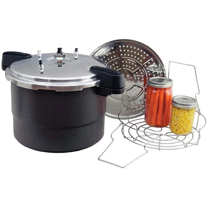 Granite Ware Pressure Canner, Cooker, and Steamer next to canning accessories and canned materials inside jars