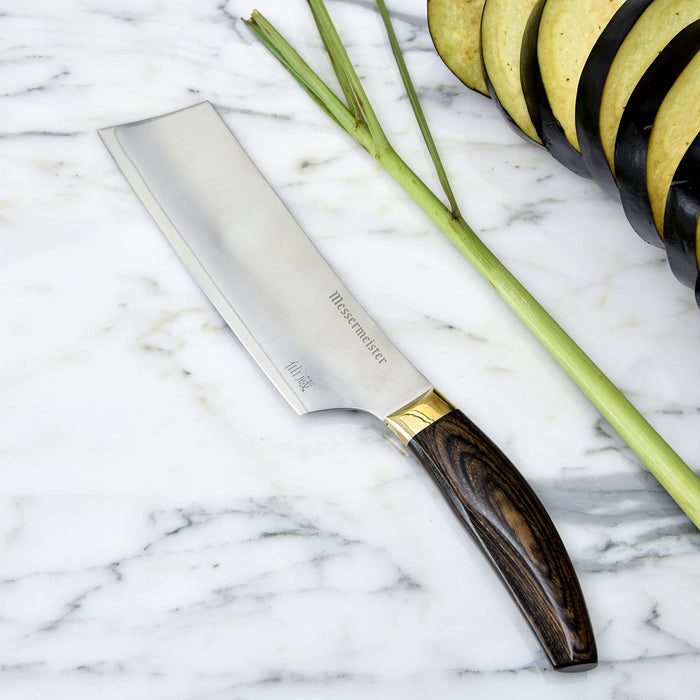 6.5 inch nakiri knife next to vegetables displayed on a marble surface