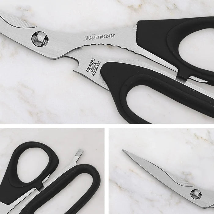 Pair of scissors with black handles on a marble surface, featuring the brand 'Messermeister'.