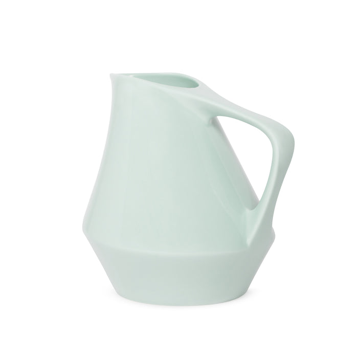 Sage green ceramic pitcher on a white background