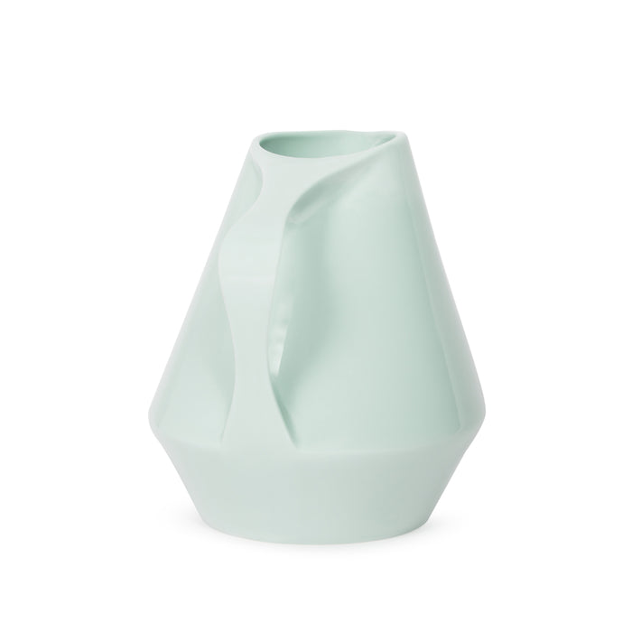 Side view of sage green ceramic pitcher on a white background