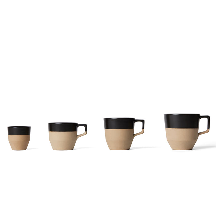 A set of ceramic notneutral cups with saucers in a variation of beige and black colors, displayed in a row.