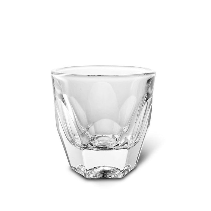 A clear hand-pressed notNeutral Vero cappuccino glass with faceted angles.