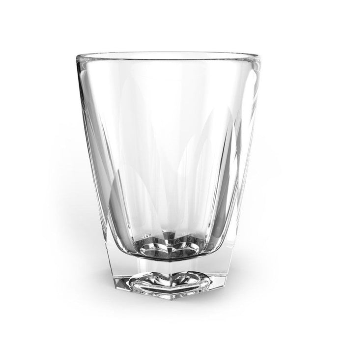 A clear hand-pressed notNeutral Vero latte glass with faceted angles.