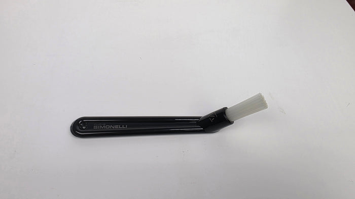 Black plastic tool with a white brush on a white background