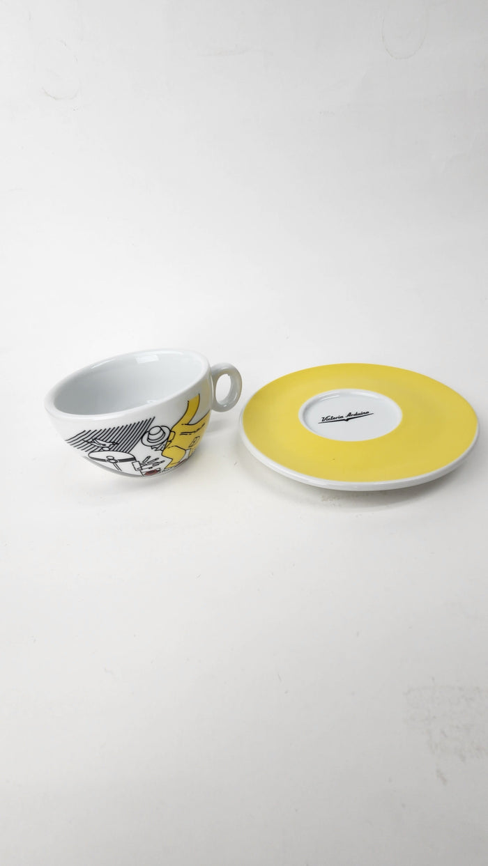 Cup and saucer with a yellow interior on a white background