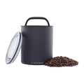 Black air-tight canister with handle and 'AIRSCAPE' branding, surrounded by coffee beans on a white background.