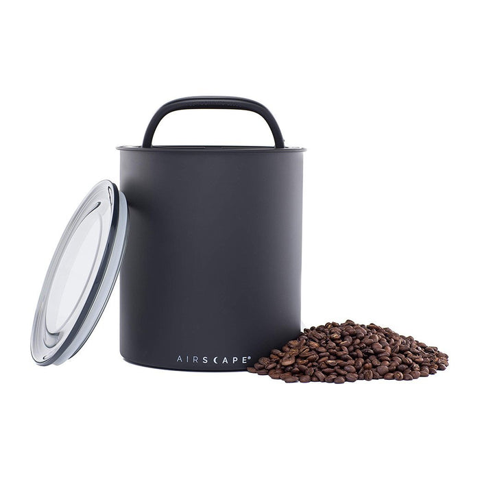 Black air-tight canister with handle and 'AIRSCAPE' branding, surrounded by coffee beans on a white background.