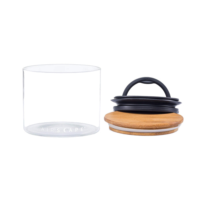 Empty medium glass airscape container with airtight lid and bamboo lid on a white background