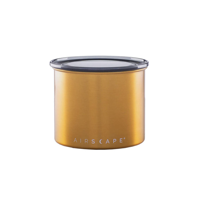 Brass-colored coffee canister with lid on a white background